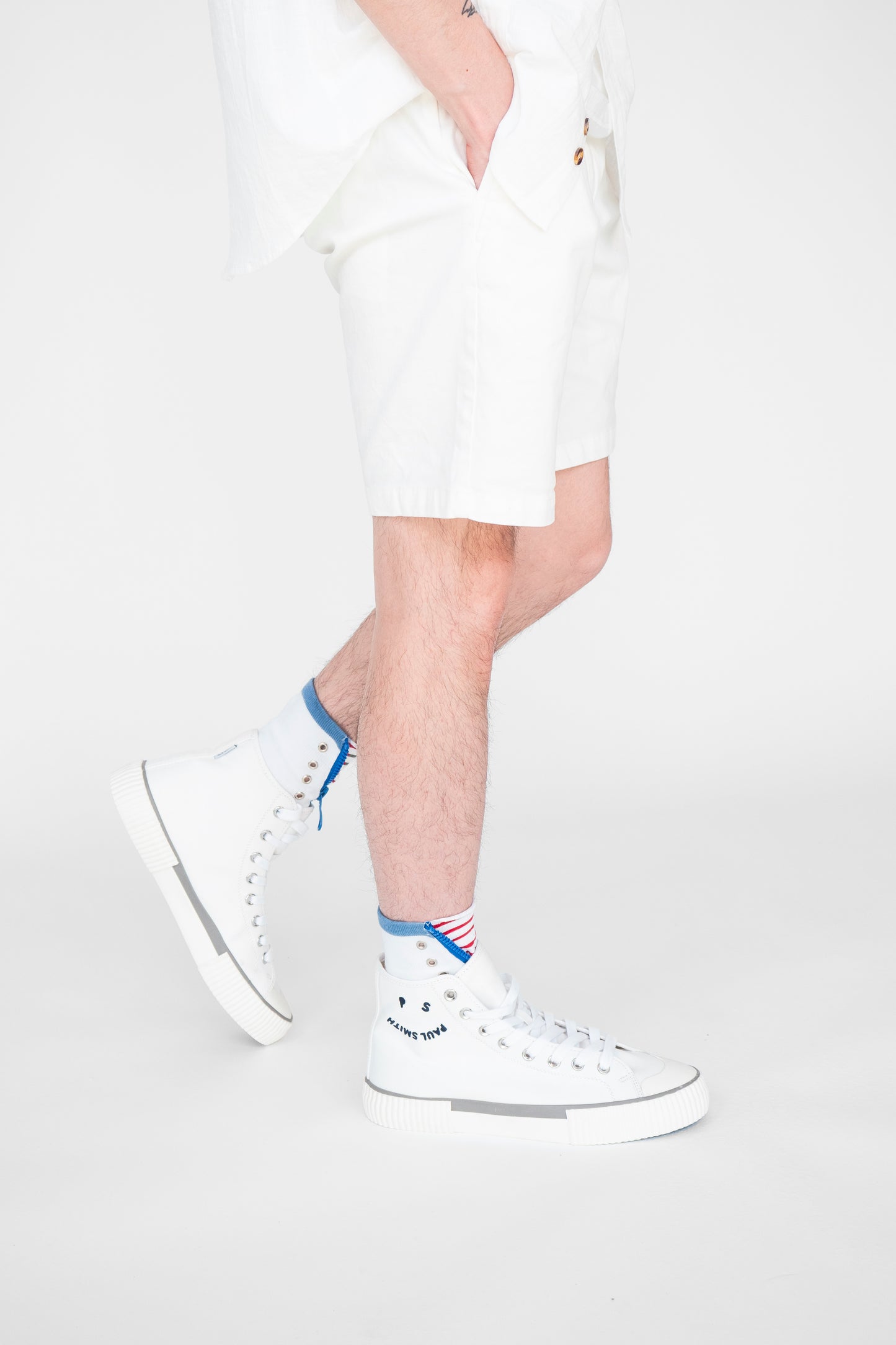 Atypical Attire socks are unique socks and luxury socks. These Striped Zip Up socks are unisex white cotton socks with a blue zip and a red striped pattern for a fun quirky style. They contain silver eyelets and can be worn zipped up or zipped down. They have a red line over the toes and outlining the heel of the sock. Worn with white trainers.