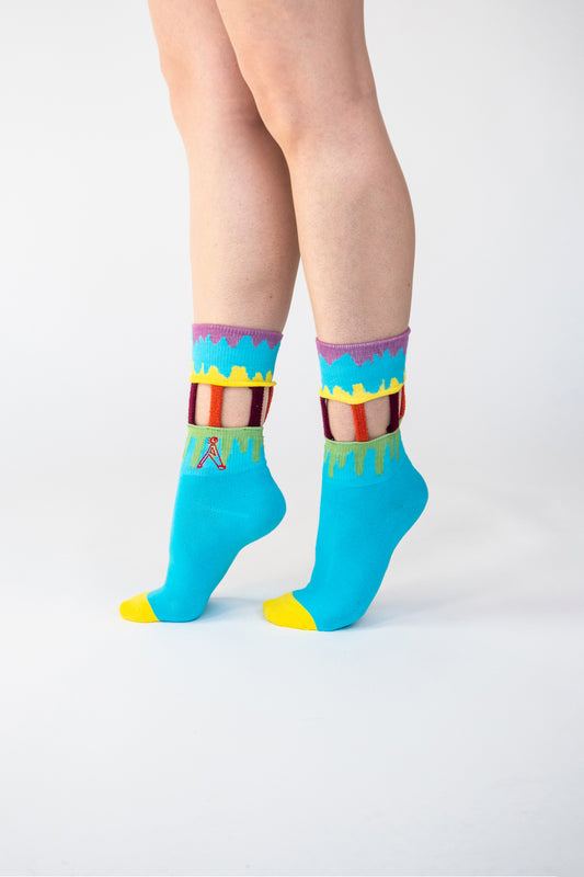 Atypical Attire socks are unique socks and luxury socks. These Ice Cream Carousel socks are unisex multicoloured cotton socks which are blue with a yellow, pink and green drip pattern and handmade strips of orange and maroon for a fun quirky style.