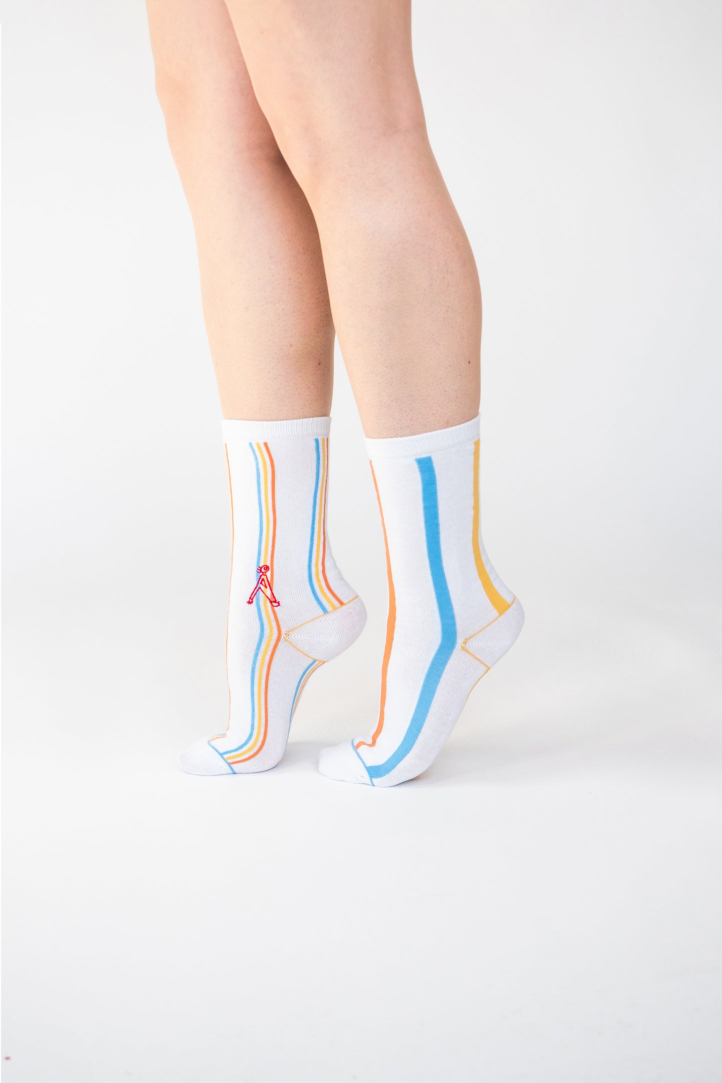 Atypical Attire socks are unique socks and luxury socks. These Multi-Striped socks are unisex white cotton socks which contain blue, yellow and orange stripes. One sock has thick stripes, the other sock has thin stripes to create a mismatching pair.