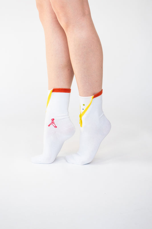 Atypical Attire socks are unique socks and luxury socks. These Dotty Spotty socks are unisex white cotton socks which contain a yellow zip and multicoloured spots. Polkadots appear in orange, blue, purple and yellow.