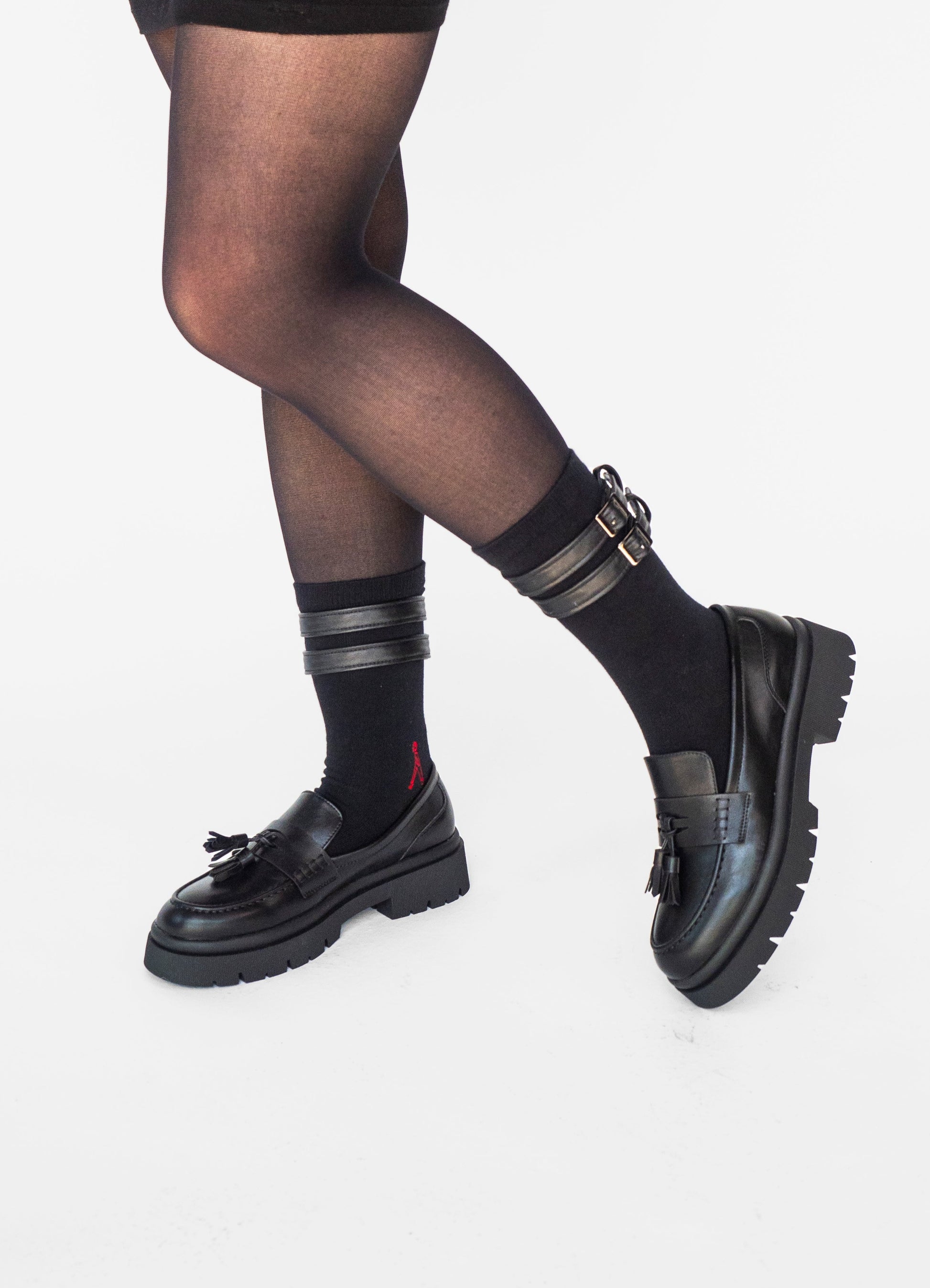 atypical attire socks are unique socks and luxury socks and these black belt socks are made from cotton and use vegan leather, worn with loafers in this image