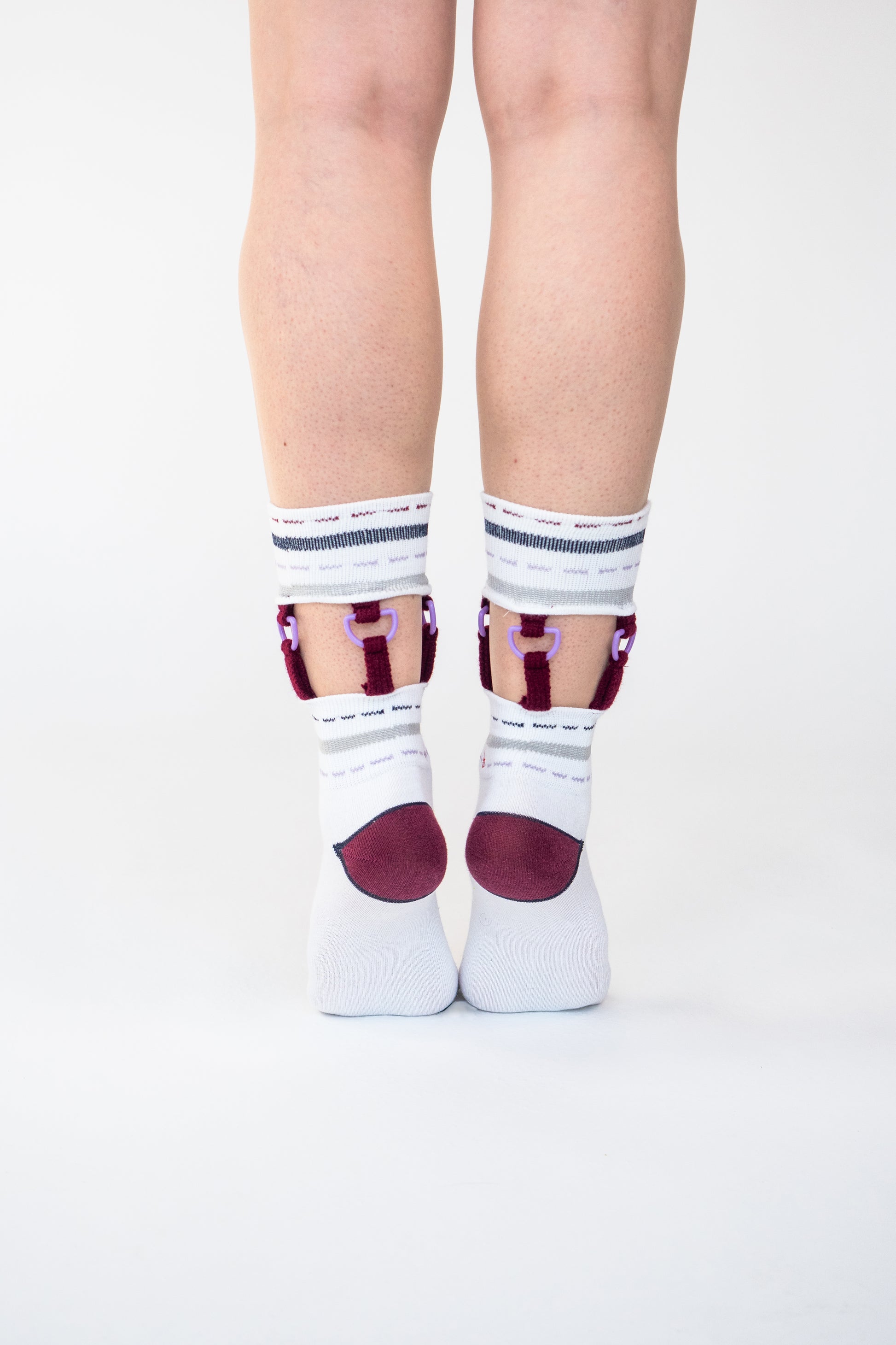 Atypical Attire socks are unique socks and luxury socks. These D-Ring Suspender socks are unisex white cotton socks which contain grey and purple stripes and colourful strips with purple D rings. 