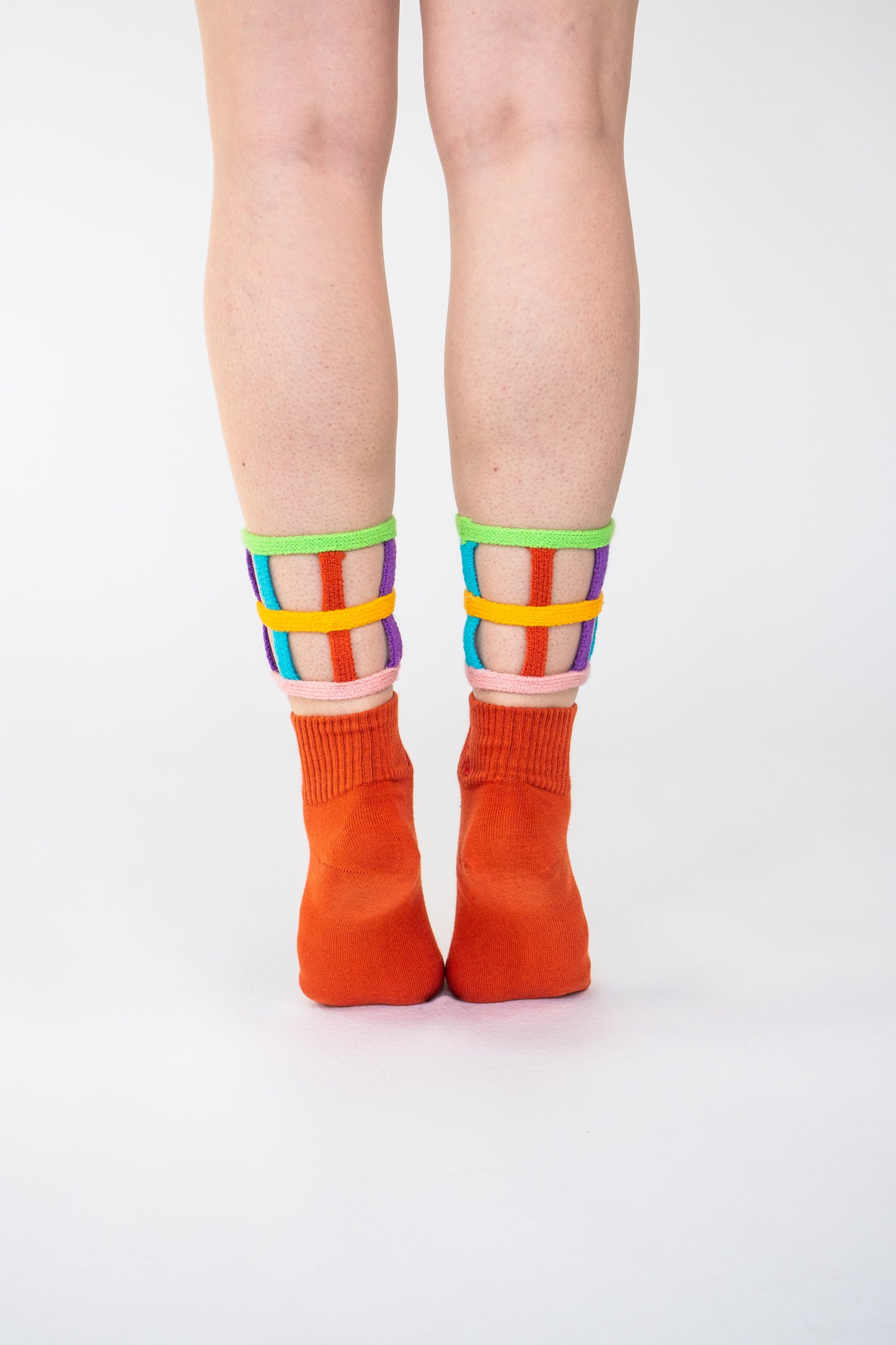 Atypical Attire socks are unique socks and luxury socks. These bright multicoloured colour cuff socks are made from cotton. They have handmade components. These are two-part orange socks with purple, pink, green, blue and yellow strips.